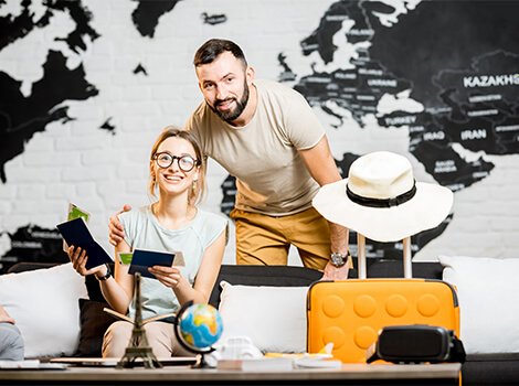 Happy woman holding flight tickets at desk