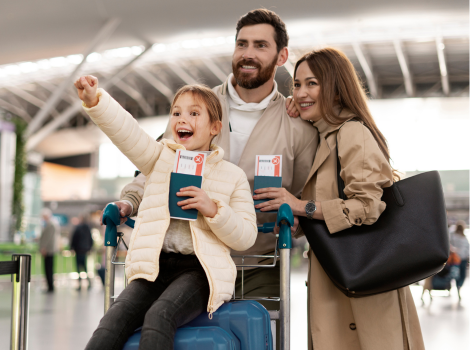 Happy woman holding flight tickets at desk